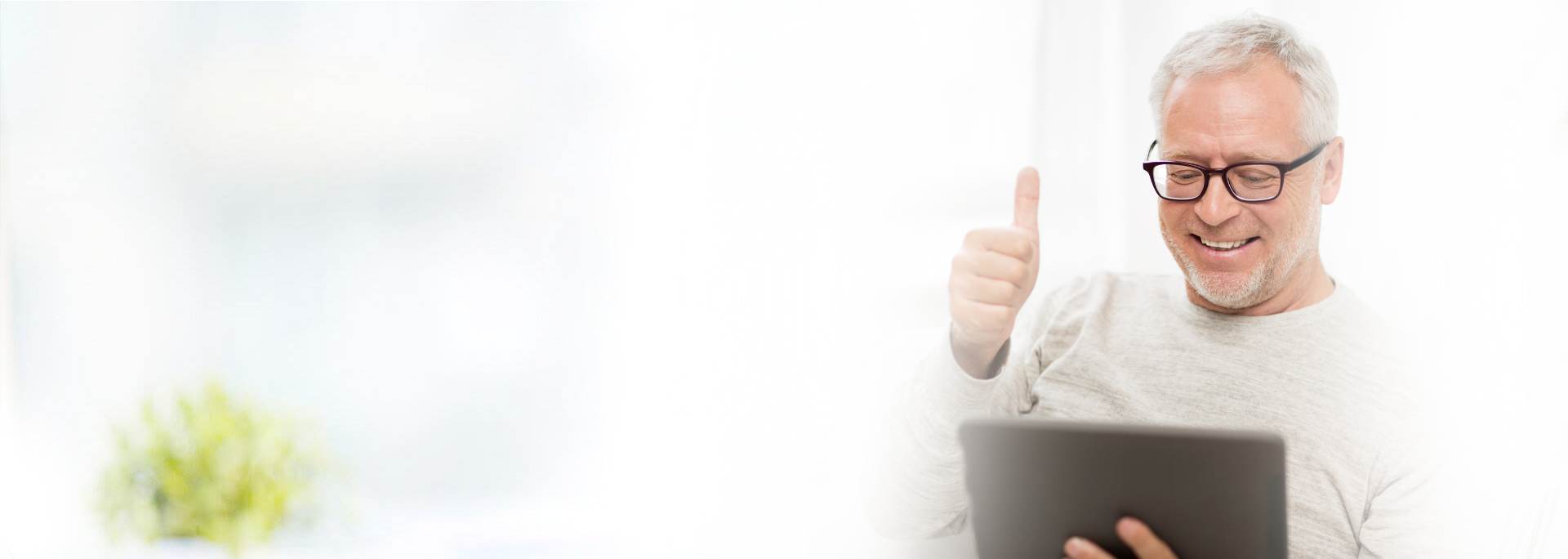 Middle age man looking over investment information on his ipad or tablet and giving a smile and thumbs up because he knows he is well covered and protected with Odiorne Insurance